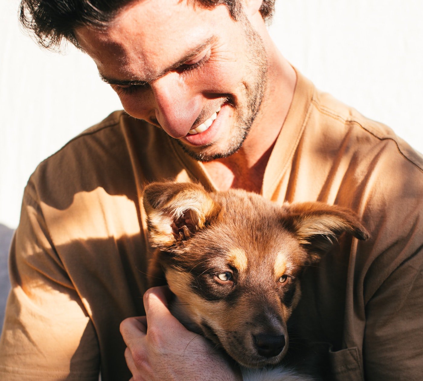 Man lovingly holding his puppy