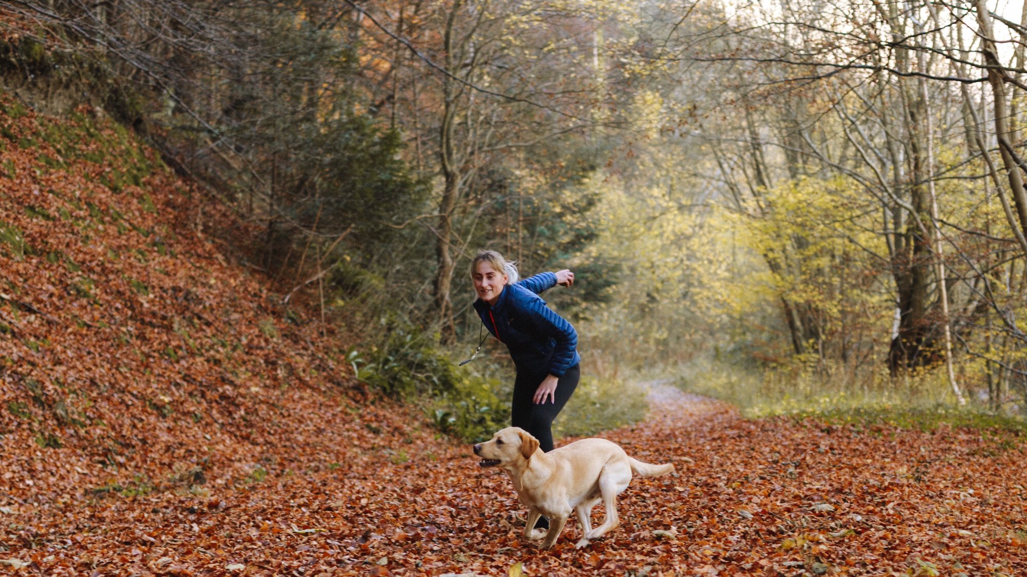 Woman and dog playing fetch